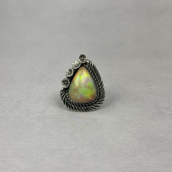 Ethiopian opal ring in sterling silver with flower accents and rope detail